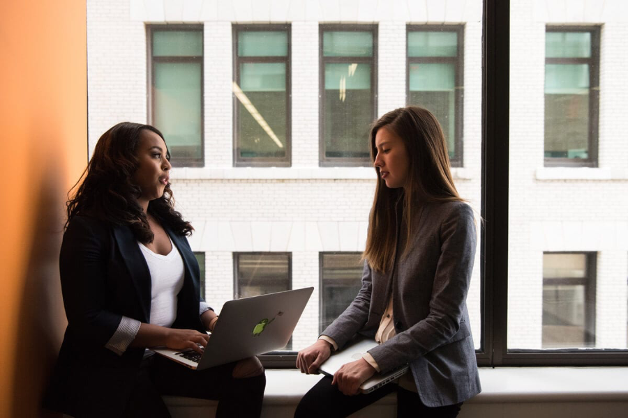 Two Women Sitting in a Meeting