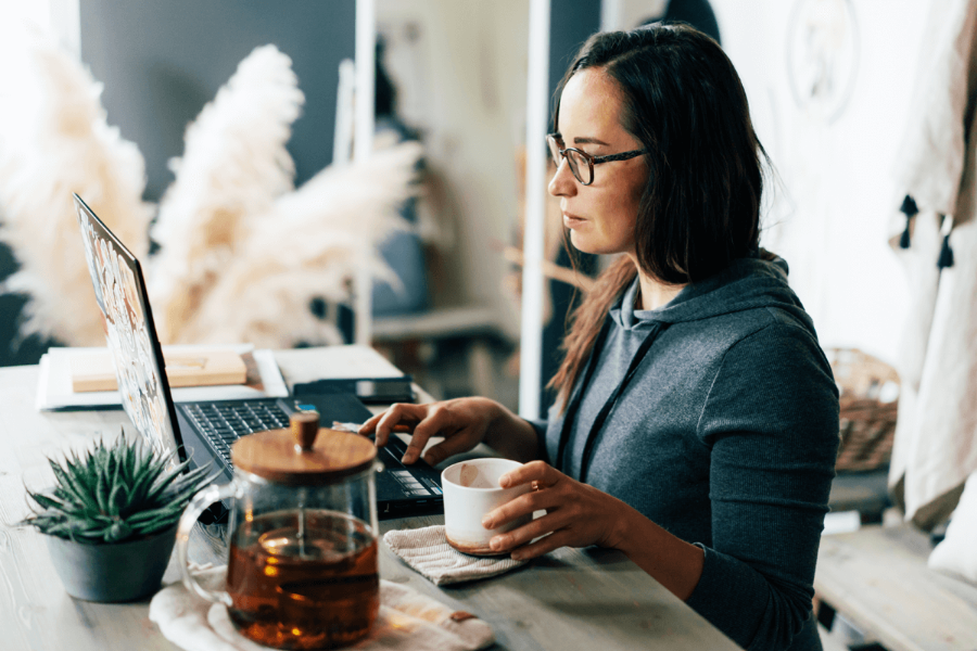 Woman working and drinking coffee